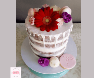 2nd Birthday Girl's Drip Birthday Cake with fresh bright flowers macrons covered in a semi naked design with round cookie treats personalised.