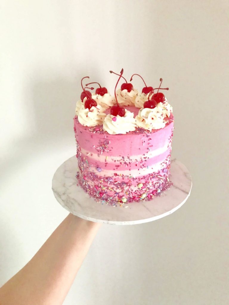 pink white stripe cake cherry on top